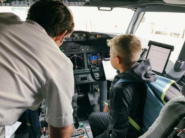 A boy in the cockpit with a pilot