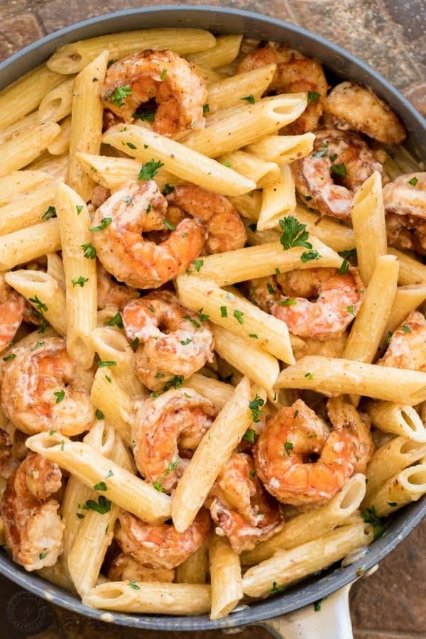 A close up of pasta and shrimp in a skillet