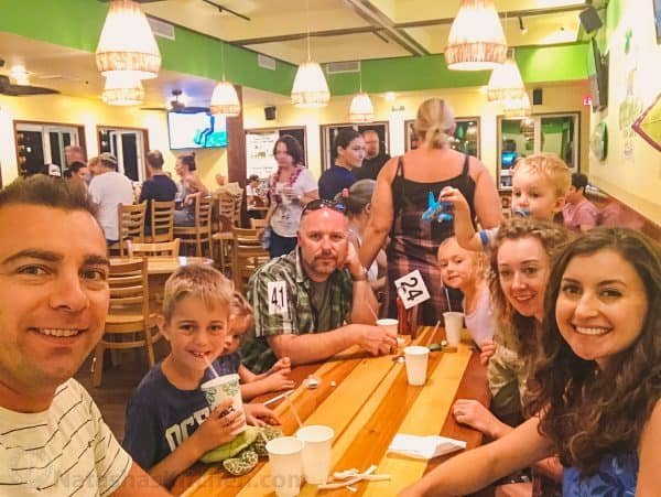 A group of people sitting around a table at a restaurant 