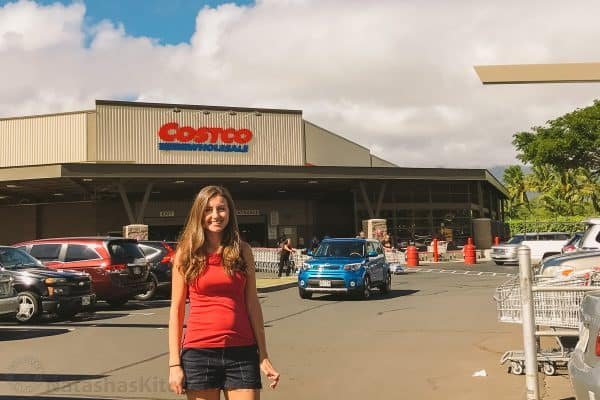 Natasha standing in a parking lot with Costco behind her 