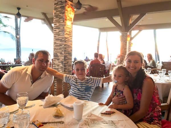 Natasha and her family sitting at a table at a restaurant 