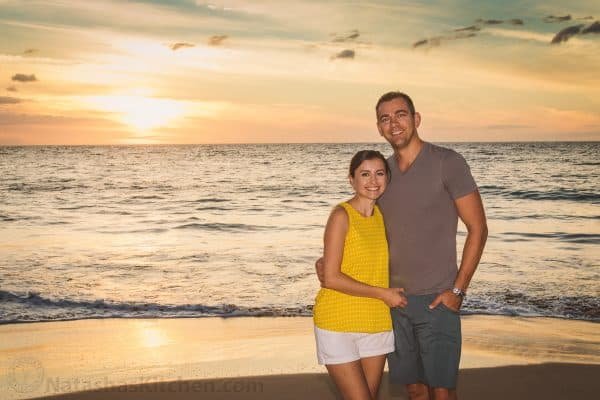 Natasha and her husband smiling at the beach
