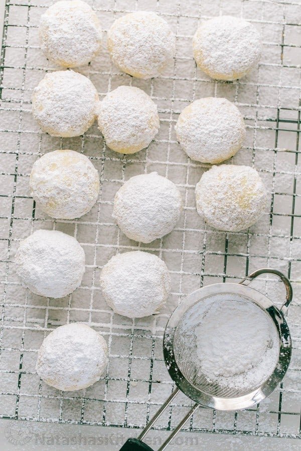 These almond snowball cookies just melt in your mouth. Perfect Christmas cookies since they look like darling little snowballs. Almond snowball cookies dusted with powdered sugar and freezer friendly