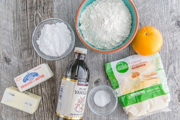 These almond snowball cookies just melt in your mouth. Perfect Christmas cookies since they look like darling little snowballs. Ingredients for snowball cookies with almond flour, butter and orange zest