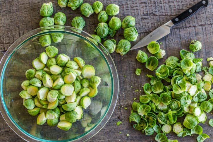 Roasted Brussels Sprouts are tender and caramelized with crisp edges. Baked Brussels sprouts are an easy, excellent side dish with just 5 ingredients. #brusselssprouts #roastedbrusselssprouts #brusselssproutsrecipe #sidedish #natashaskitchen #brusselsprouts How to Trim Brussels Sprouts