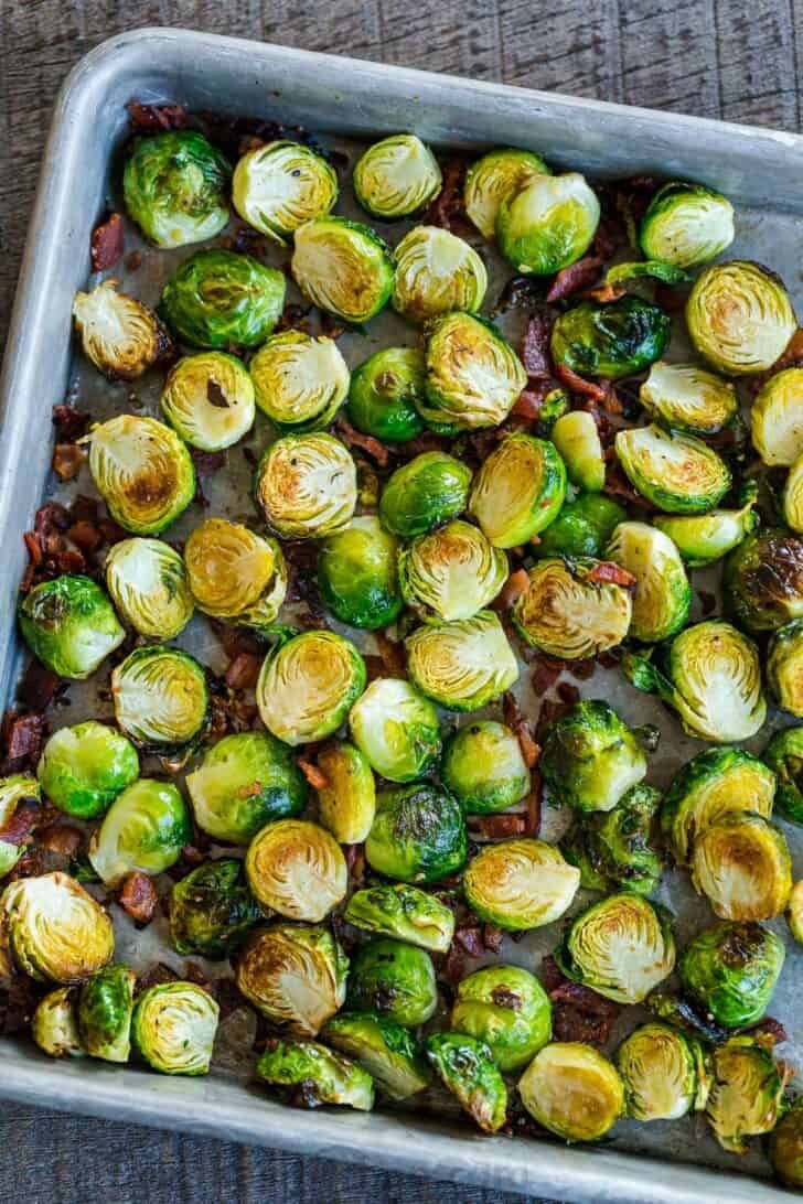 Roasted Brussels Sprouts are tender and caramelized with crisp edges. Baked Brussels sprouts are an easy, excellent side dish with just 5 ingredients. #brusselssprouts #roastedbrusselssprouts #brusselssproutsrecipe #sidedish #natashaskitchen #brusselsprouts Reheating Brussels sprouts in the oven or air fryer on baking sheet