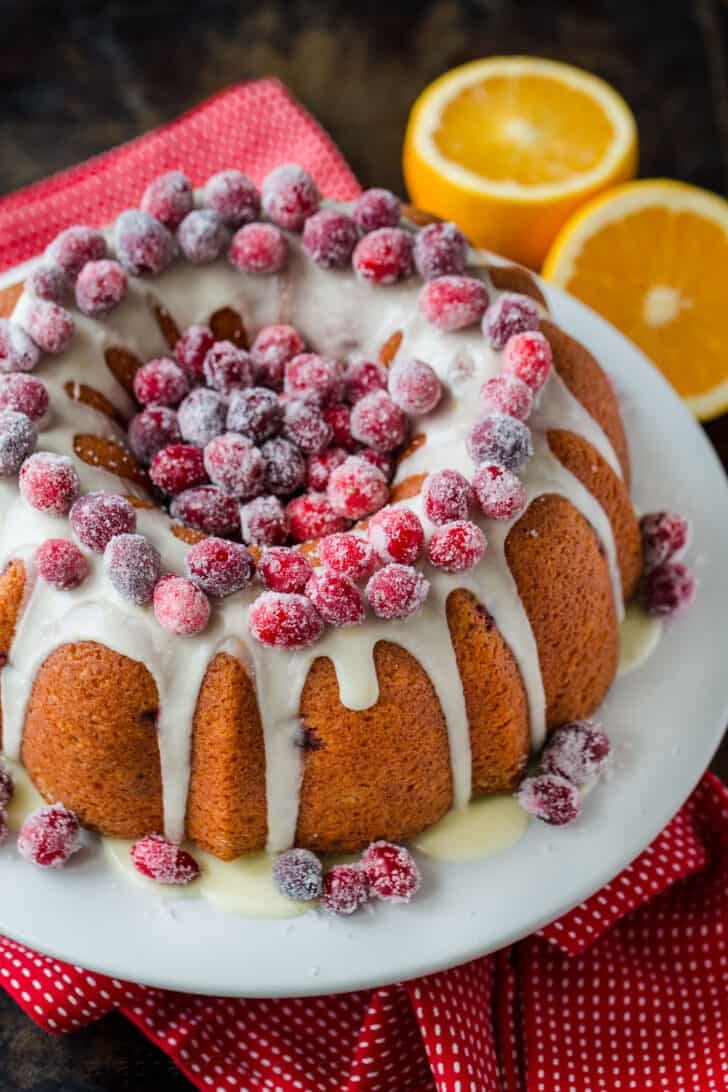Cranberry orange cake glazed and topped with sugared cranberries