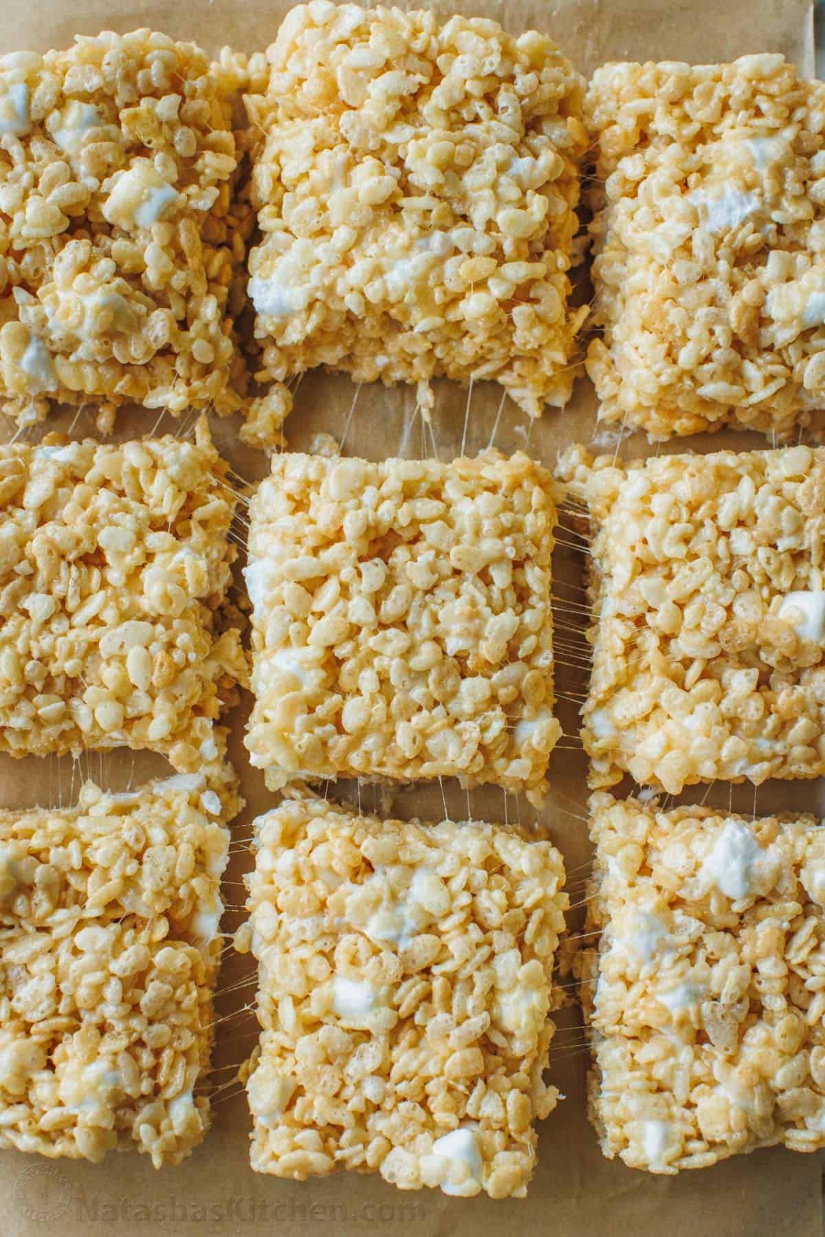 Make thick and gooey Rice Krispie Treats filled with sweet and sticky marshmallows and crispy rice crunch. A family-favorite no-bake dessert! Overhead view of Rice Krispie treats cut into squares.