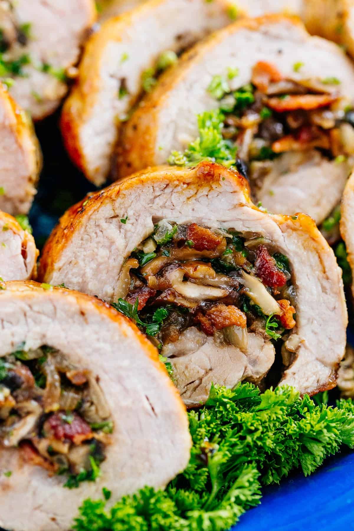 Juicy Stuffed Pork Tenderloin recipe loaded with mushrooms and bacon. With just a few ingredients, this easy pork recipe is a crowd favorite! A juicy Stuffed Pork Tenderloin loaded with mushrooms and bacon.
