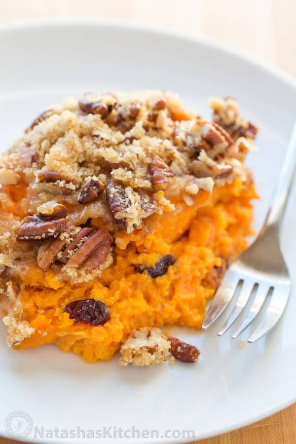 A plate with sweet potato casserole and next to it a fork 