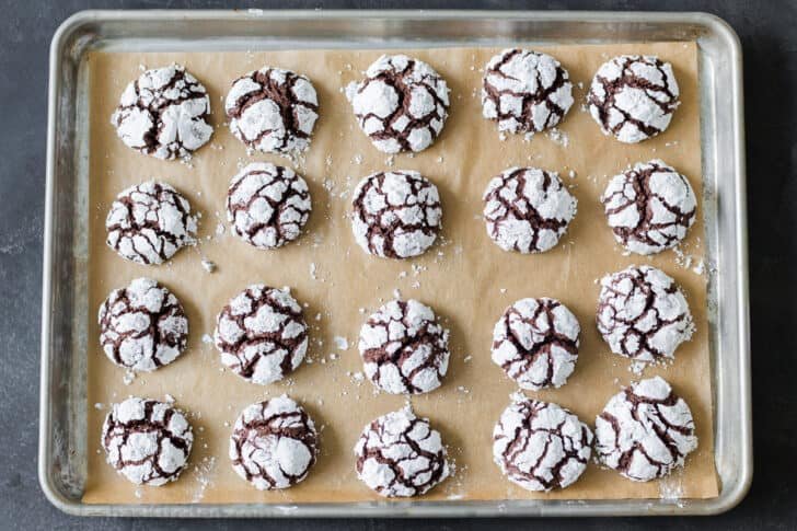 Chocolate Crinkle Cookies are like a cross between the gooiest brownie you have ever had and a crispy chocolate chip cookie A tray of baked chocolate crinkle cookies