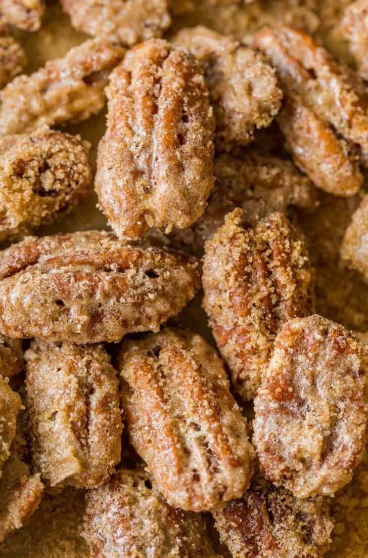 Candied pecans are easy and great for munching, gifting, and topping. The cinnamon sugar caramelizes and gives them a delicate praline crunch Candied praline pecans up close showing crunchy texture