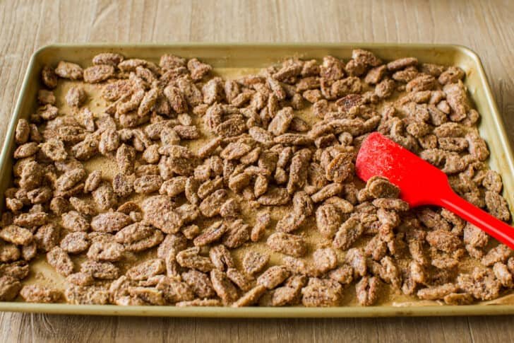 Candied pecans are easy and great for munching, gifting, and topping. The cinnamon sugar caramelizes and gives them a delicate praline crunch Baked Candied pecans on baking sheet