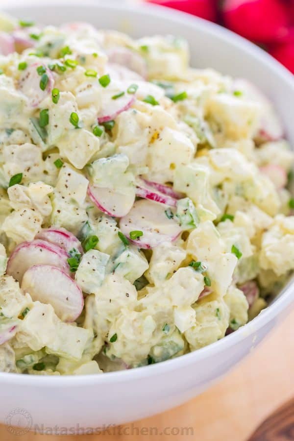 How to serve potato salad in a bowl garnished with chives and black pepper