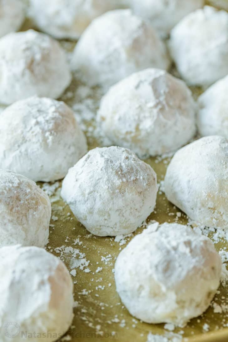 Russian Tea Cakes are easy to make and melt-in-your-mouth delicious. Add these little snowball cookies to your Christmas cookie platter. Russian tea cakes rolled in powdered sugar