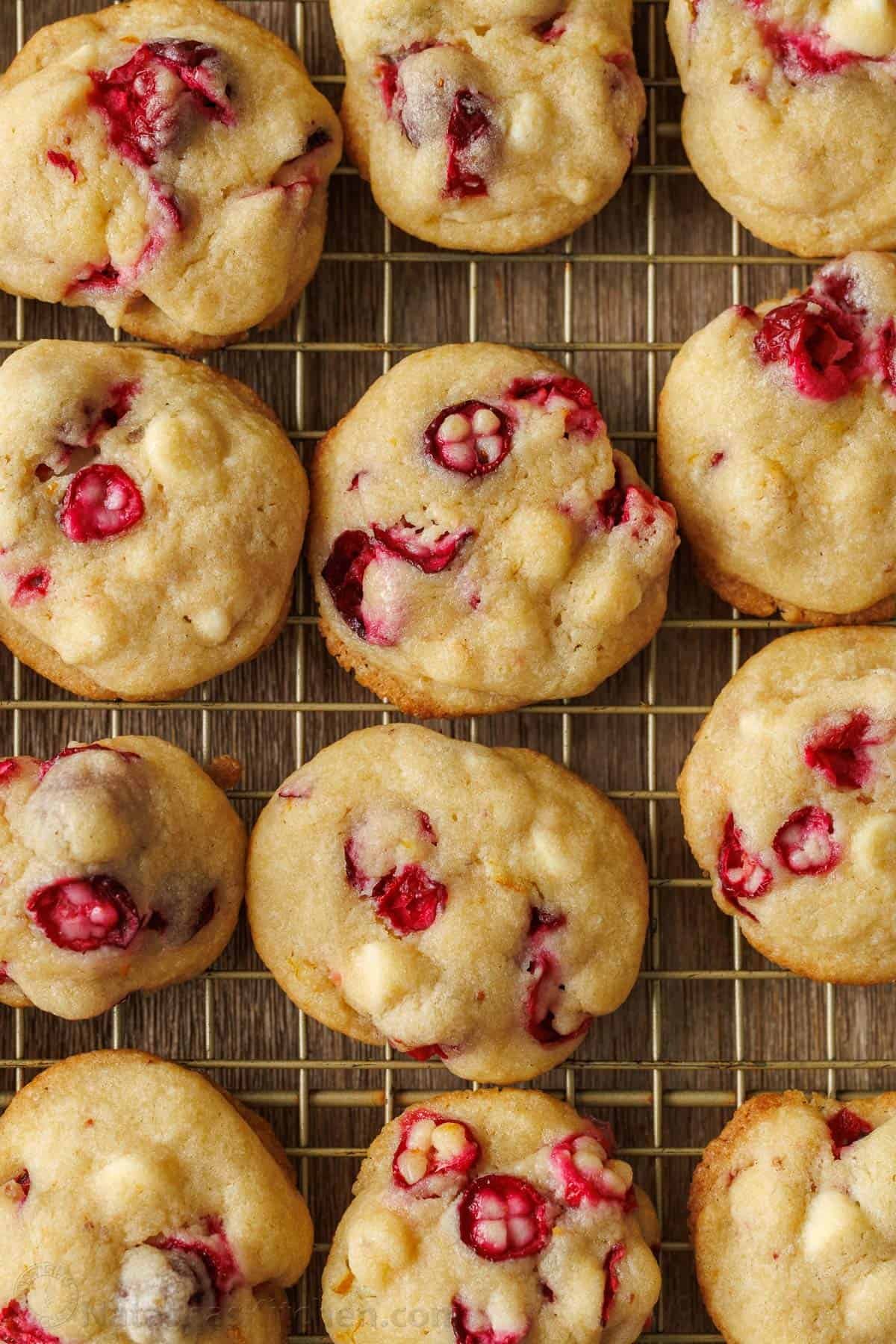 These White Chocolate Cranberry Cookies are soft and chewy festive treats with white chocolate chips and orange zest, a perfect blend of sweet and tart. Cranberry white chocolate cookies cooling on a wire rack