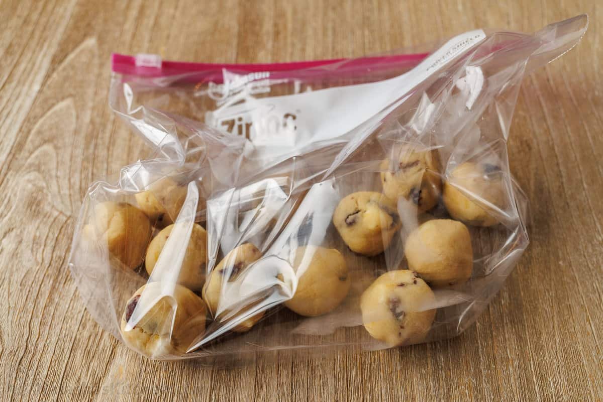 These White Chocolate Cranberry Cookies are soft and chewy festive treats with white chocolate chips and orange zest, a perfect blend of sweet and tart. Frozen cookie dough balls in a freezer safe ziploc bag
