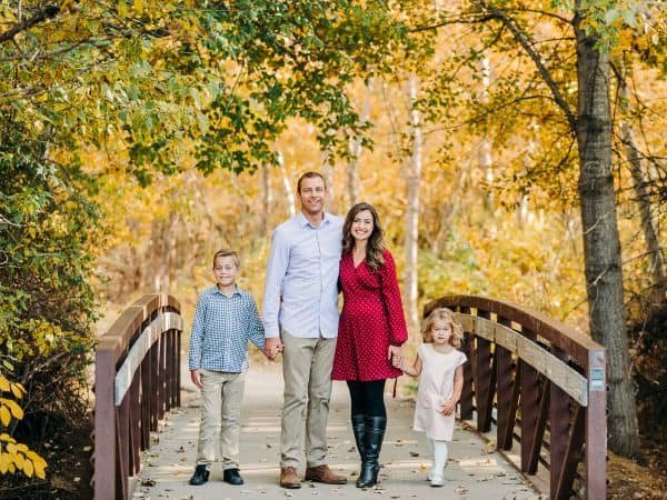 A family posing on a bridge 