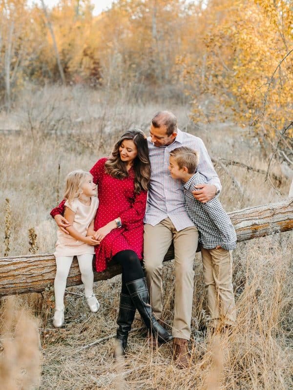 A photo of a family sitting on a tree