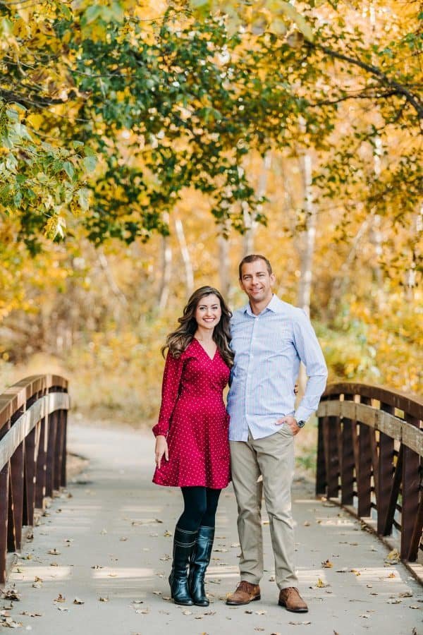 A couple standing on a bridge 