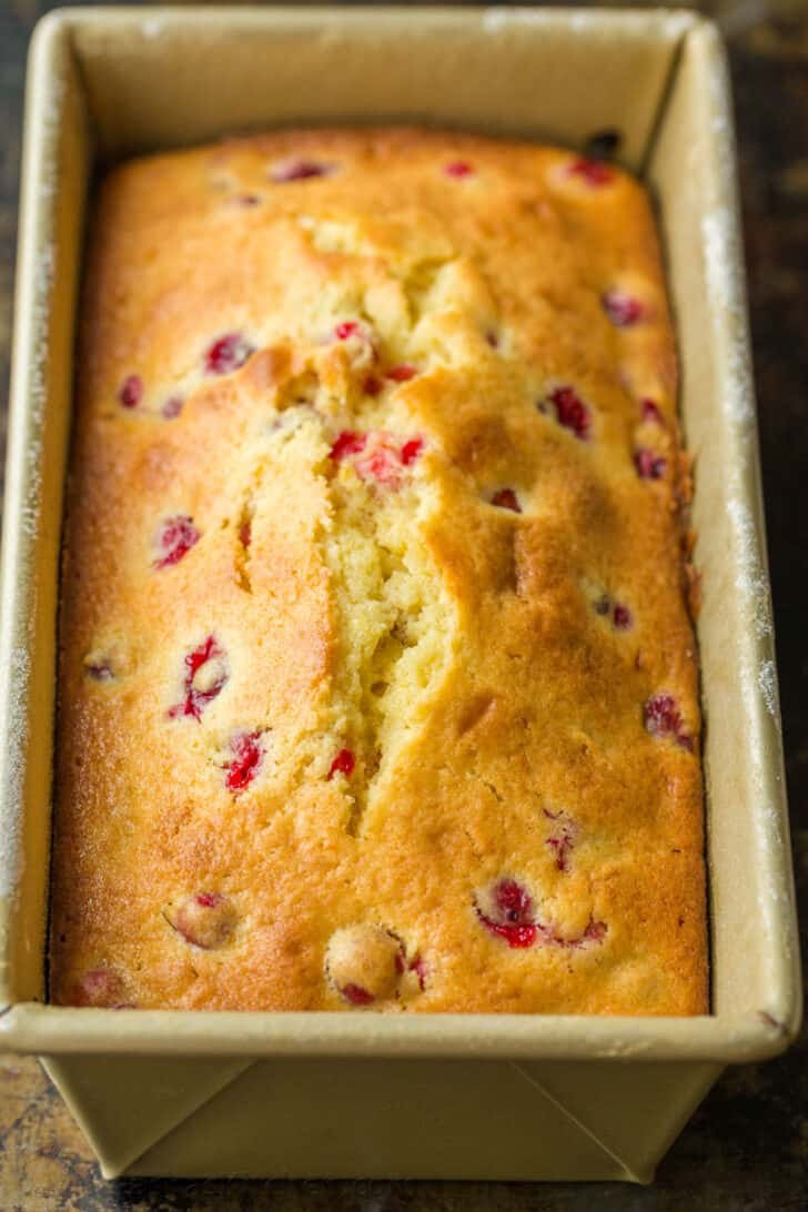 Orange-glazed Cranberry bread with a moist and tender crumb and loaded with juicy cranberries. The cranberry loaf stays moist for days. Cranberry Orange bread in loaf pan