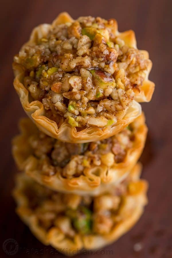 Mini Baklava Cups taste like authentic baklava but easier! The honey and lemon syrup make these baklava cups completely irresistible. A make-ahead recipe! | natashaskitchen.com