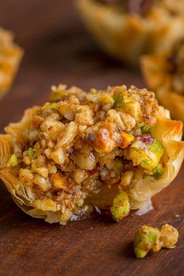 Mini Baklava Cups taste like authentic baklava but easier! The honey and lemon syrup make these baklava cups completely irresistible. A make-ahead recipe! | natashaskitchen.com