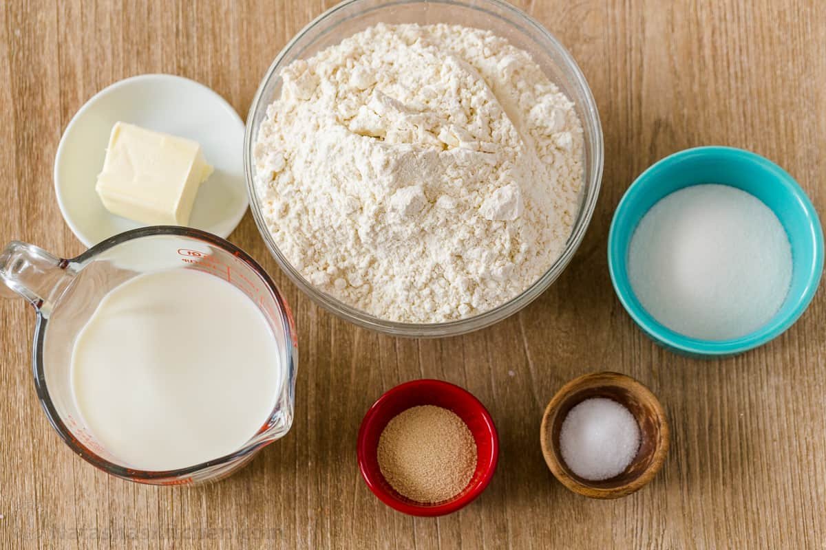 ingredients for dinner rolls with flour, milk, butter, salt, sugar and yeast