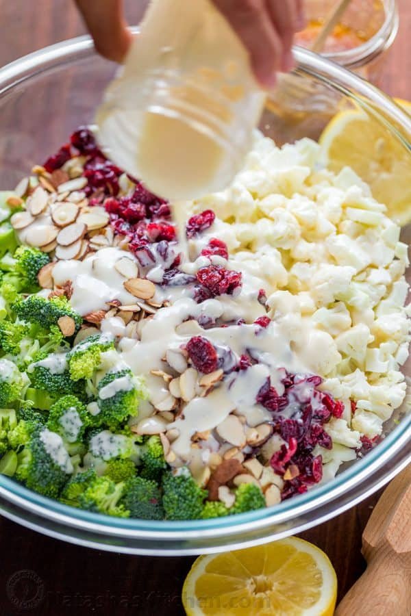 Broccoli Cauliflower Salad with honey lemon dressing always gets rave reviews. An easy, 7-ingredient favorite potluck and party salad recipe. Drizzling broccoli cauliflower salad with creamy dressing