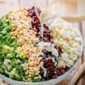 broccoli cauliflower salad drizzled with creamy dressing