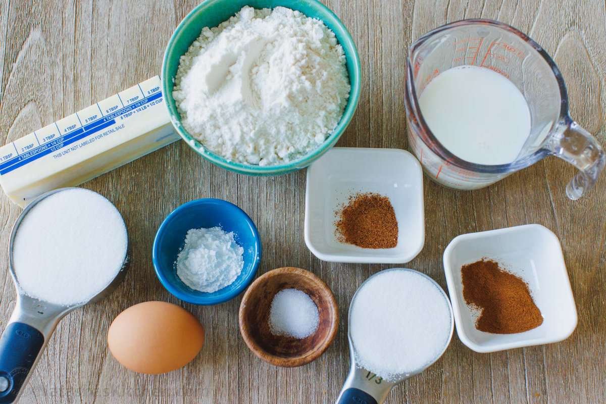 Fluffy cinnamon muffins filled with warm spice and dipped in cinnamon sugar for an irresistible, sugary crunch. Ready in 25 minutes! The ingredients for homemade cinnamon muffins with cinnamon sugar coating.