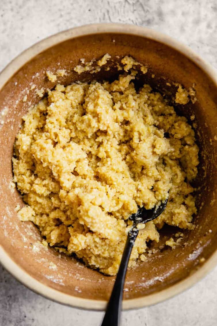 A bowl of matzo ball dough with a silver spoon.