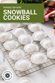Snowball cookies in mini cupcake liners arranged on a wire rack. Text overlay includes recipe name.