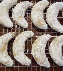 Overhead image of nut crescent cookies on a cooling rack.