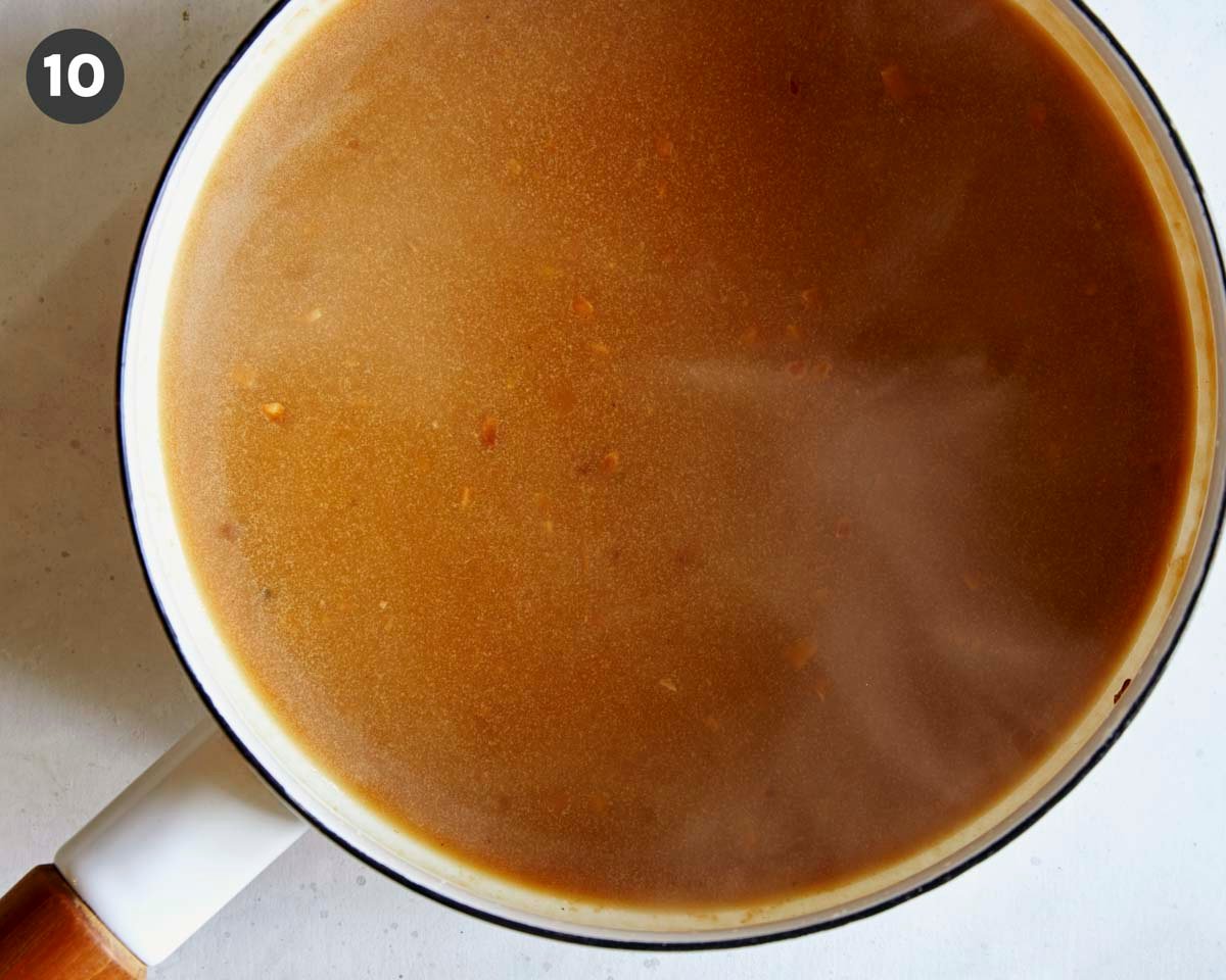 Roast beef gravy in a pot.