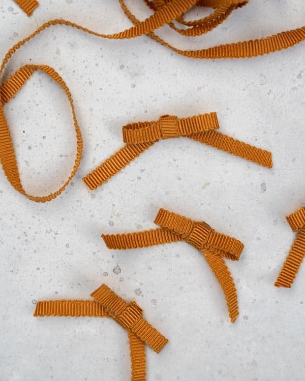 Bows made out of mustard colored ribbon.