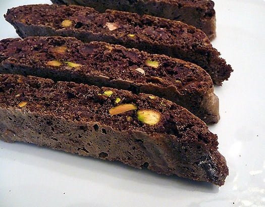 Chocolate pistachio biscotti on a white plate.