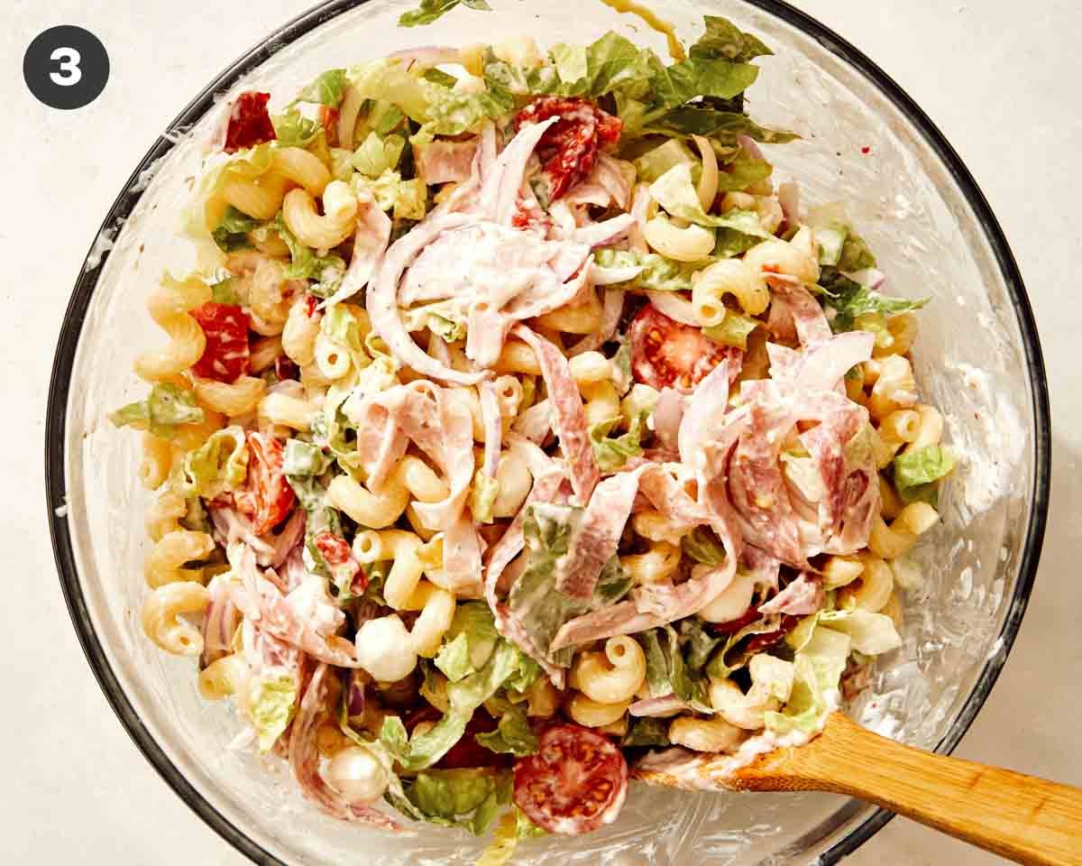 Grinder pasta salad recipe in a bowl just mixed together with the dressing.