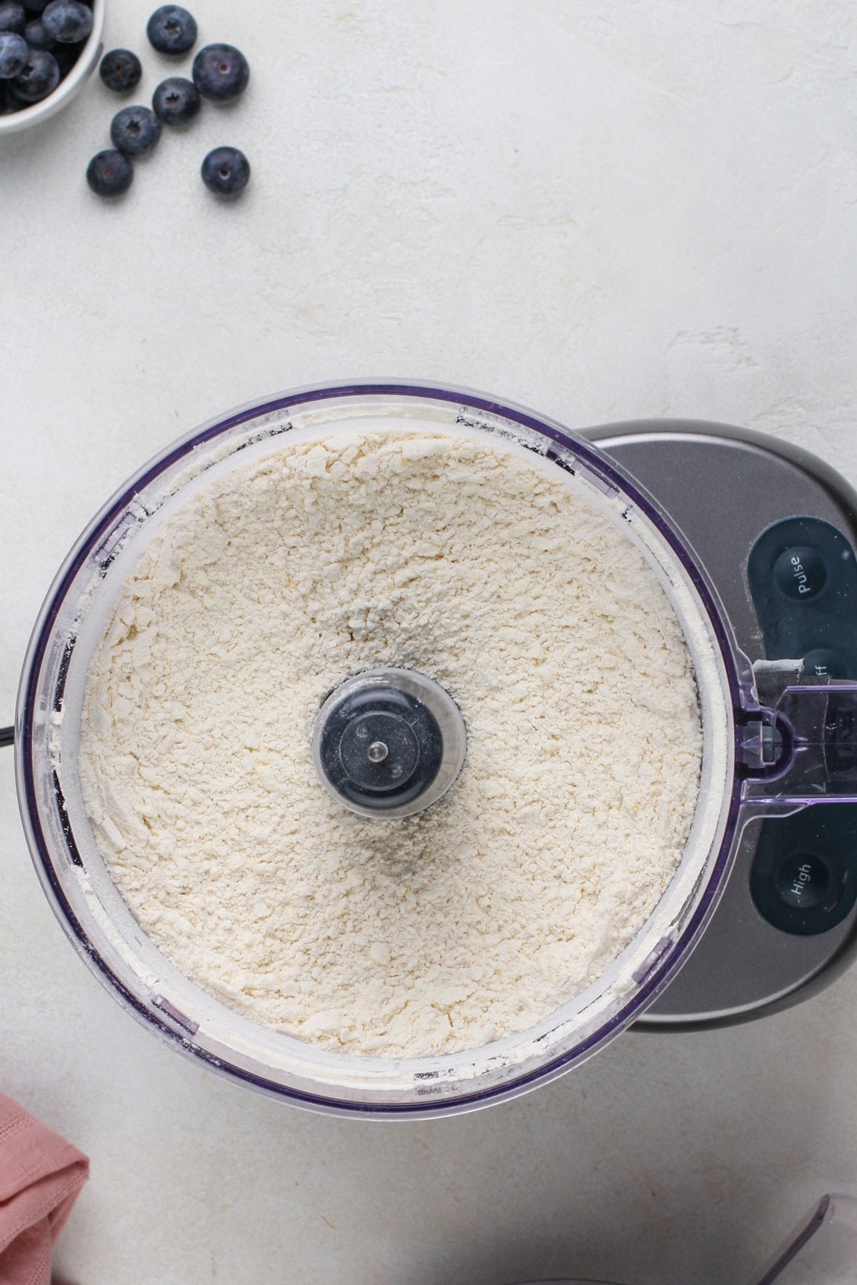 Dry ingredients for crumb bar dough pulsed in a food processor.