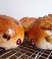 Side view of cranberry walnut rolls on a cooling rack.