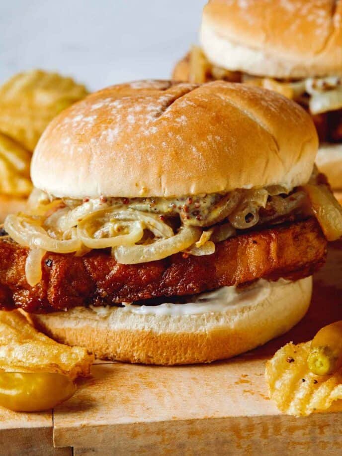 Close up on a pork chop sandwich.