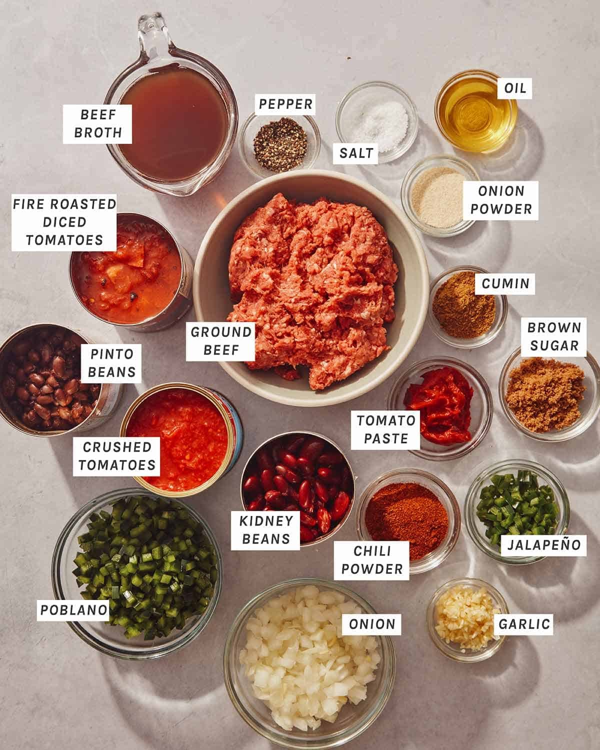 Chili ingredients all measured out on a kitchen counter.
