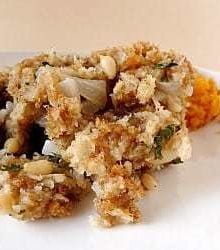 A serving of bread stuffing on a white plate.