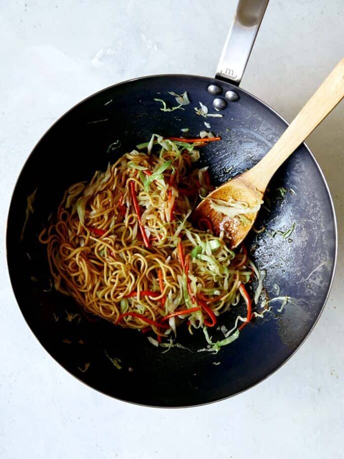 Chow Mein in a wok tossed together with the Chow Mein Sauce. 