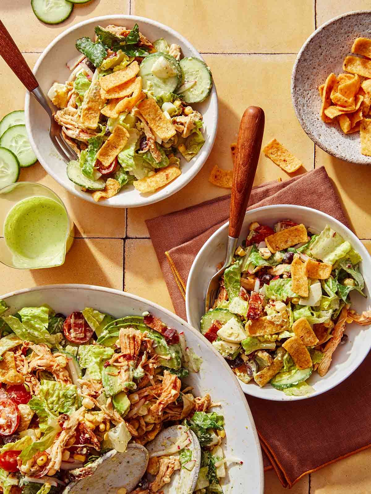 Southwest cobb salad mixed and served into bowls.