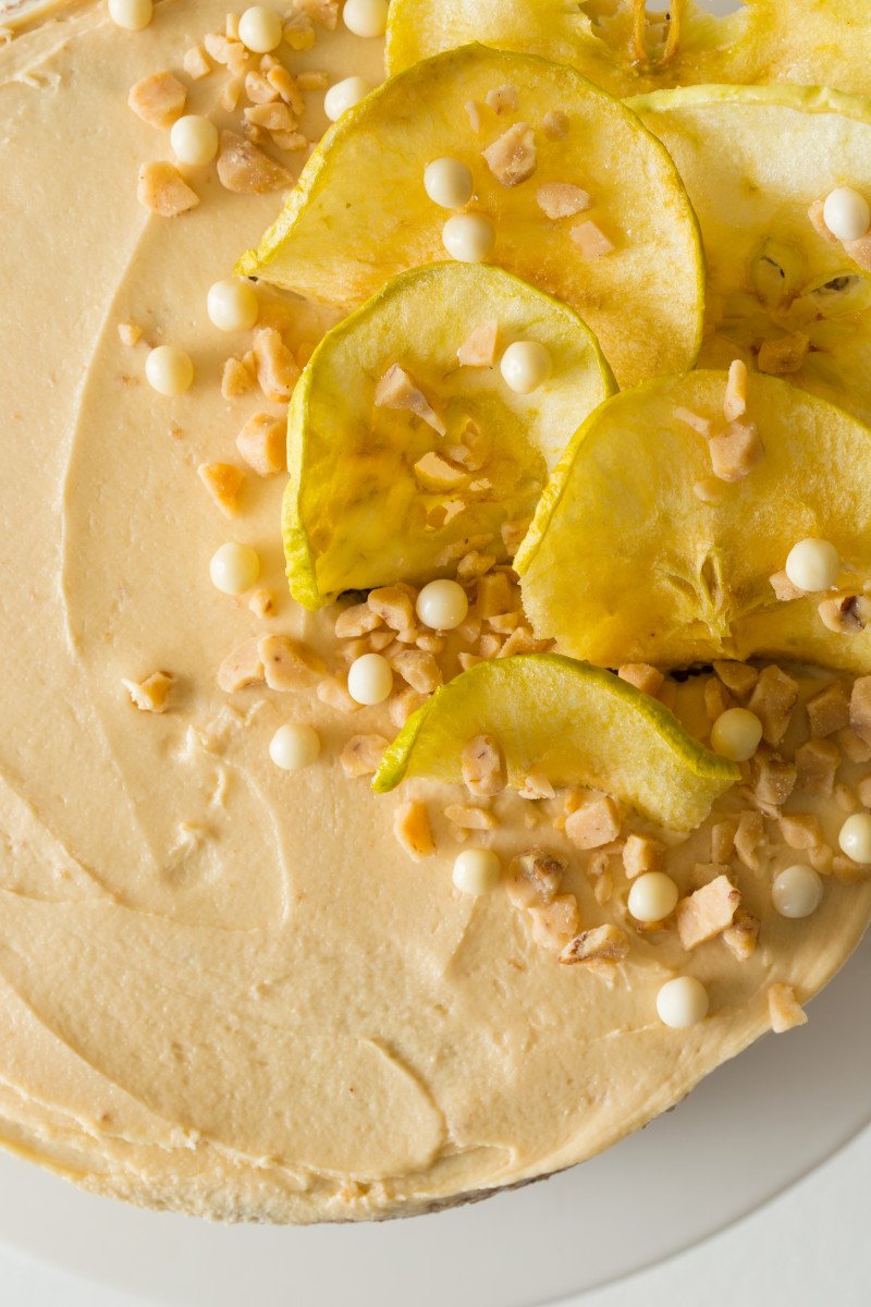 The top of an apple thyme cake with salted caramel buttercream and apple decorations.