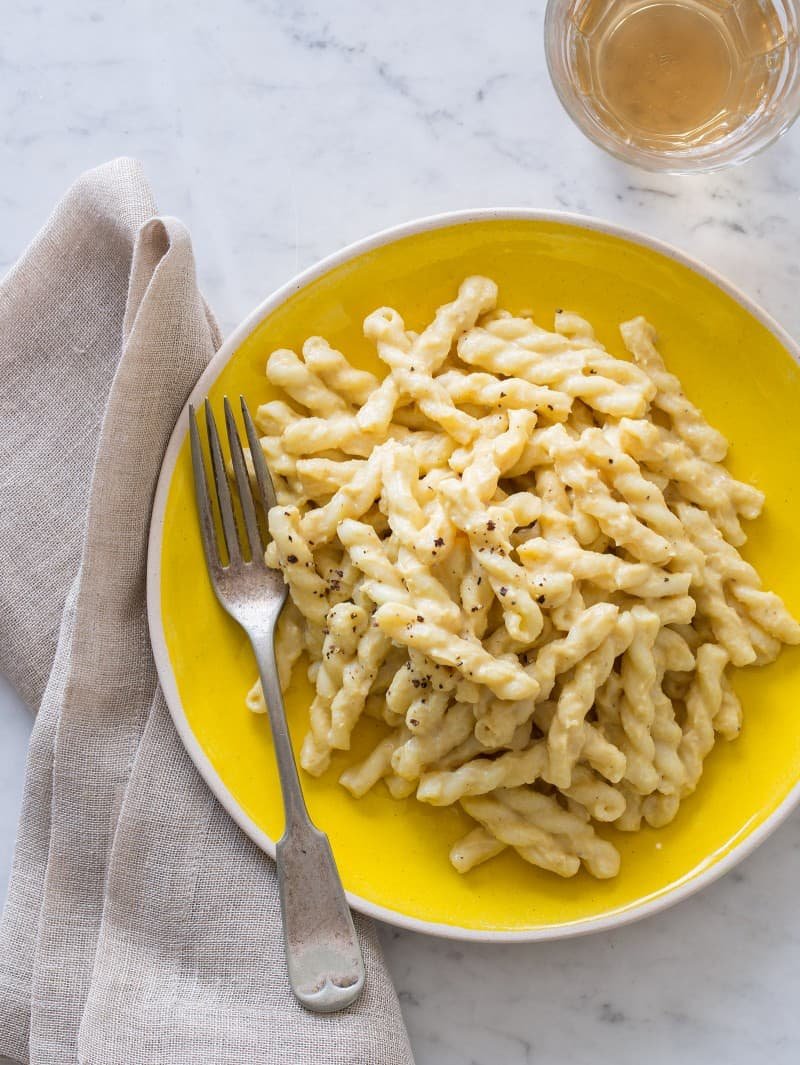 Cauliflower Cream Sauce Vegan recipe A plate of vegan cauliflower cream sauce on pasta with a fork and napkin.