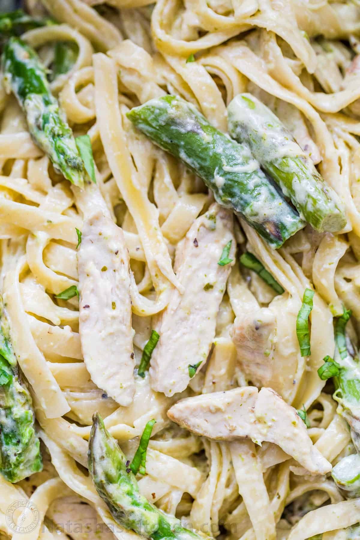 Chicken Pesto Pasta is an easy, 30-minute pasta dinner loaded with juicy chicken and asparagus. Try this crowd-pleasing pasta recipe! Fettuccini noodles tossed with asparagus in a creamy white sauce
