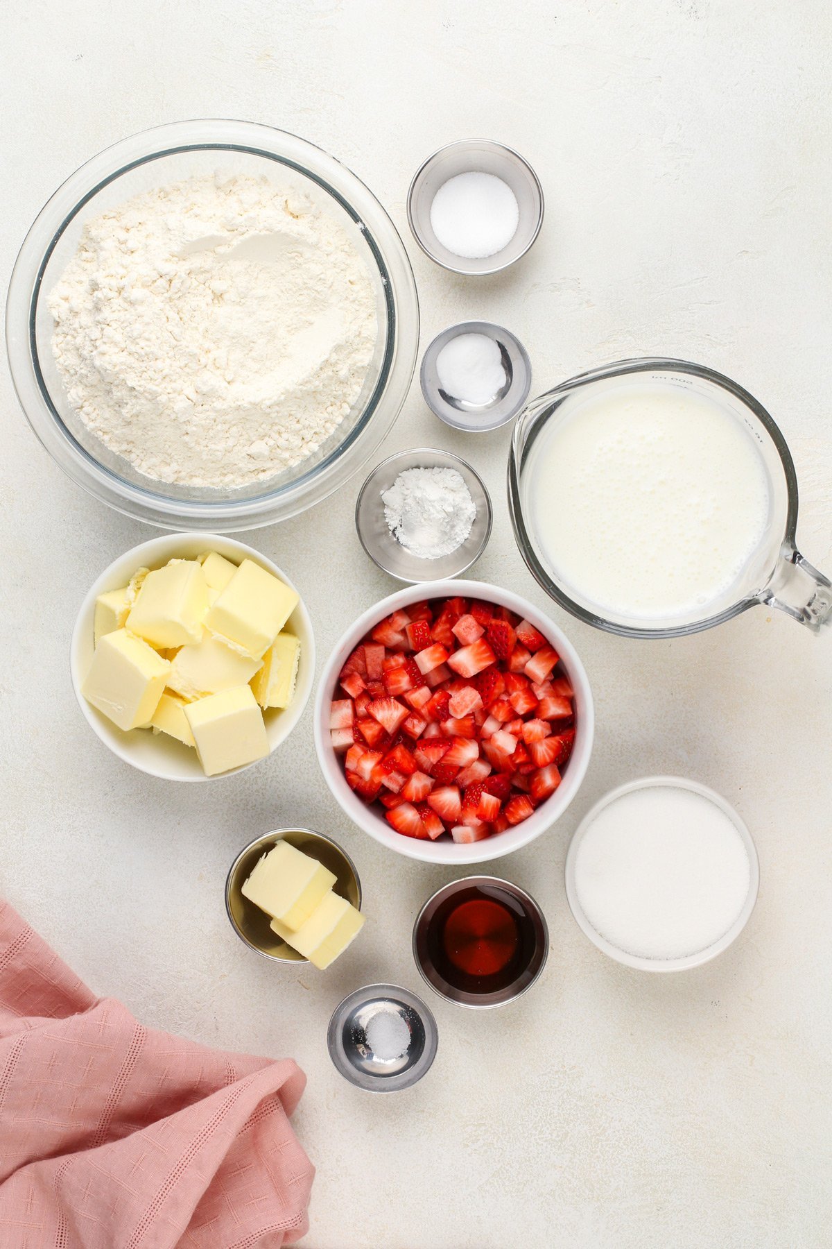 Strawberry biscuit ingredients arranged on a countertop.