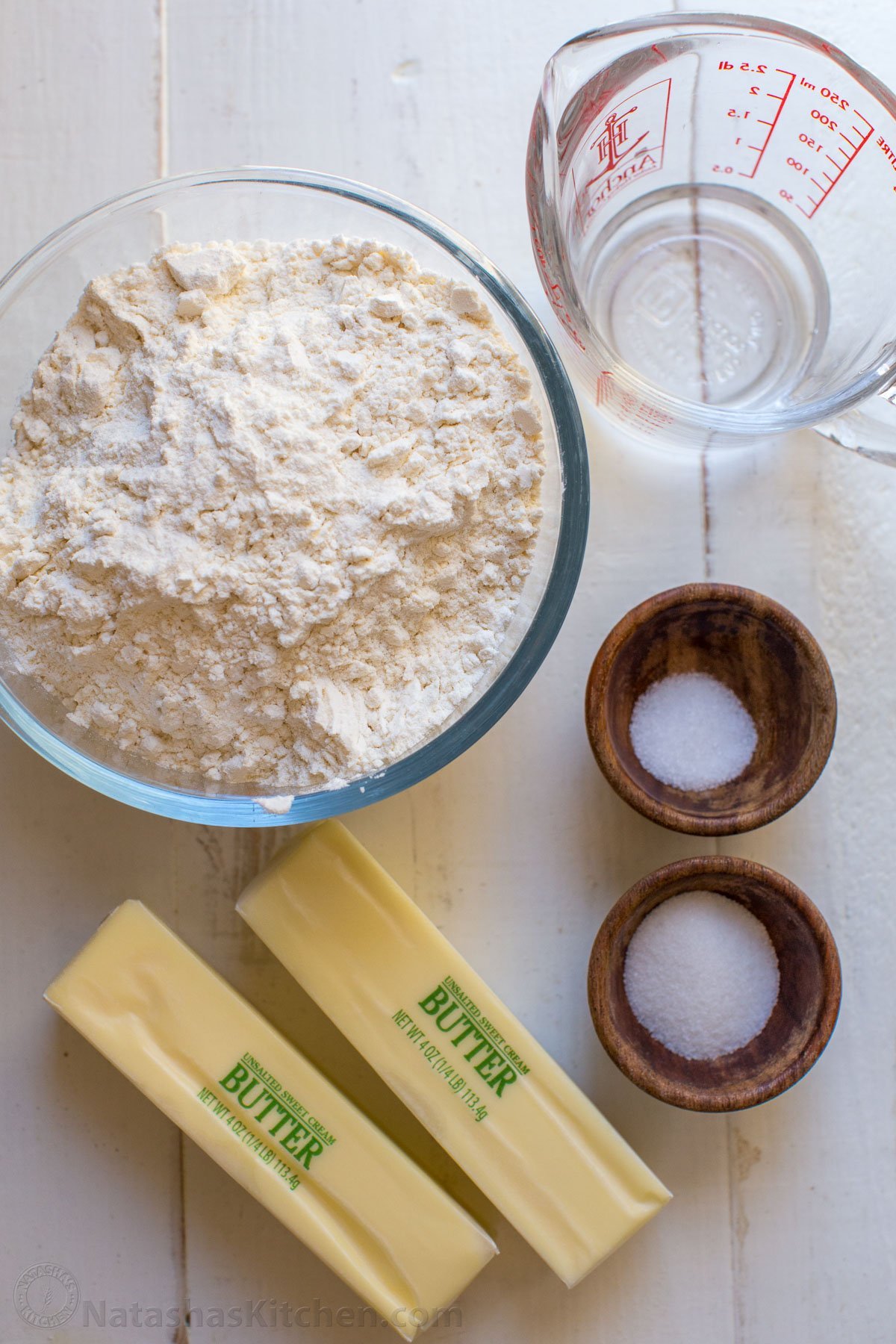 This homemade Pie Crust recipe yields a flaky, tender crust with rich buttery flavor. An easy pie dough - perfect for sweet or savory pies. Ingredients for homemade pie crust with flour, water, salt, sugar and butter.